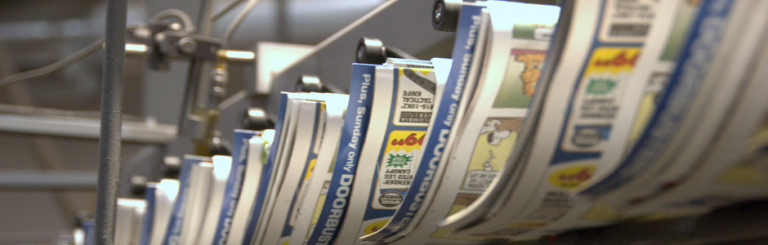 A web printing operation using a continuous roll of paper, fed through a printing press at high speeds.