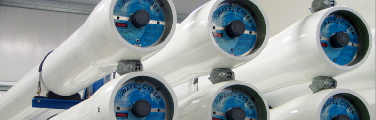 Multiple white cylindrical reverse osmosis membrane housings with blue ends labeled "WAVE CYBER" in an industrial setting.