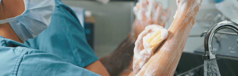 Medical personnel scrubbing in a pre-surgical setting