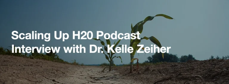 Banner entitled "Scaling Up H20 Podcast: Interview with Dr. Kelle Zeiher," overlayed by an image of corn plants in dry soil.